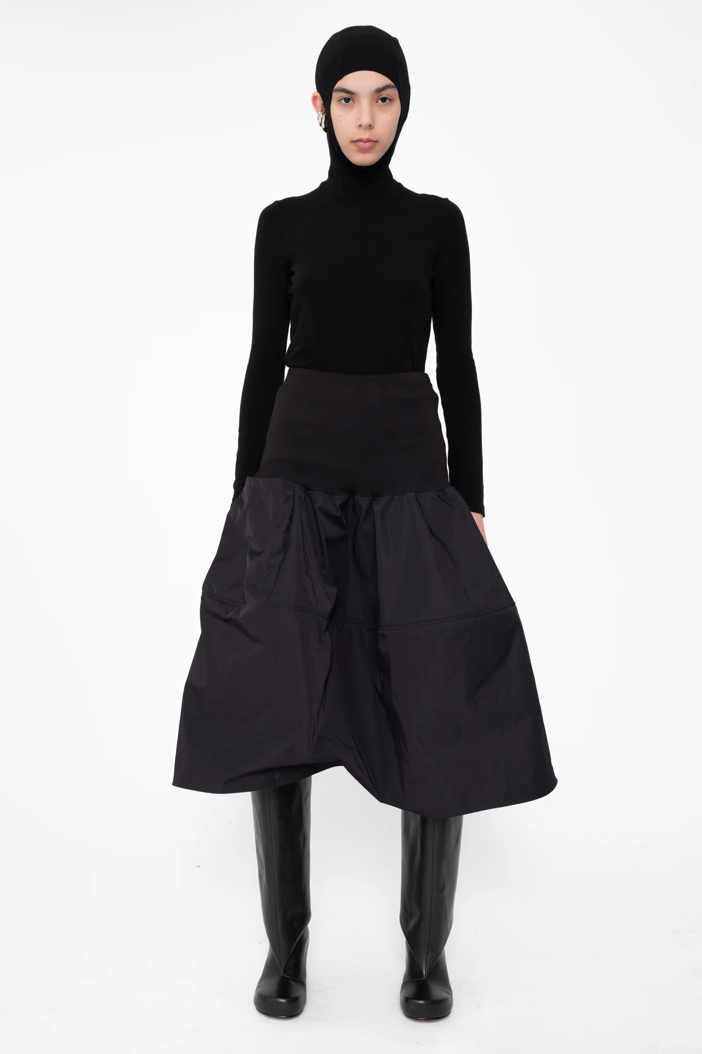 female-wearing-black-balaclava-top-with-ear-cutouts-and-black-midi-skirt-on-white-background-full-body