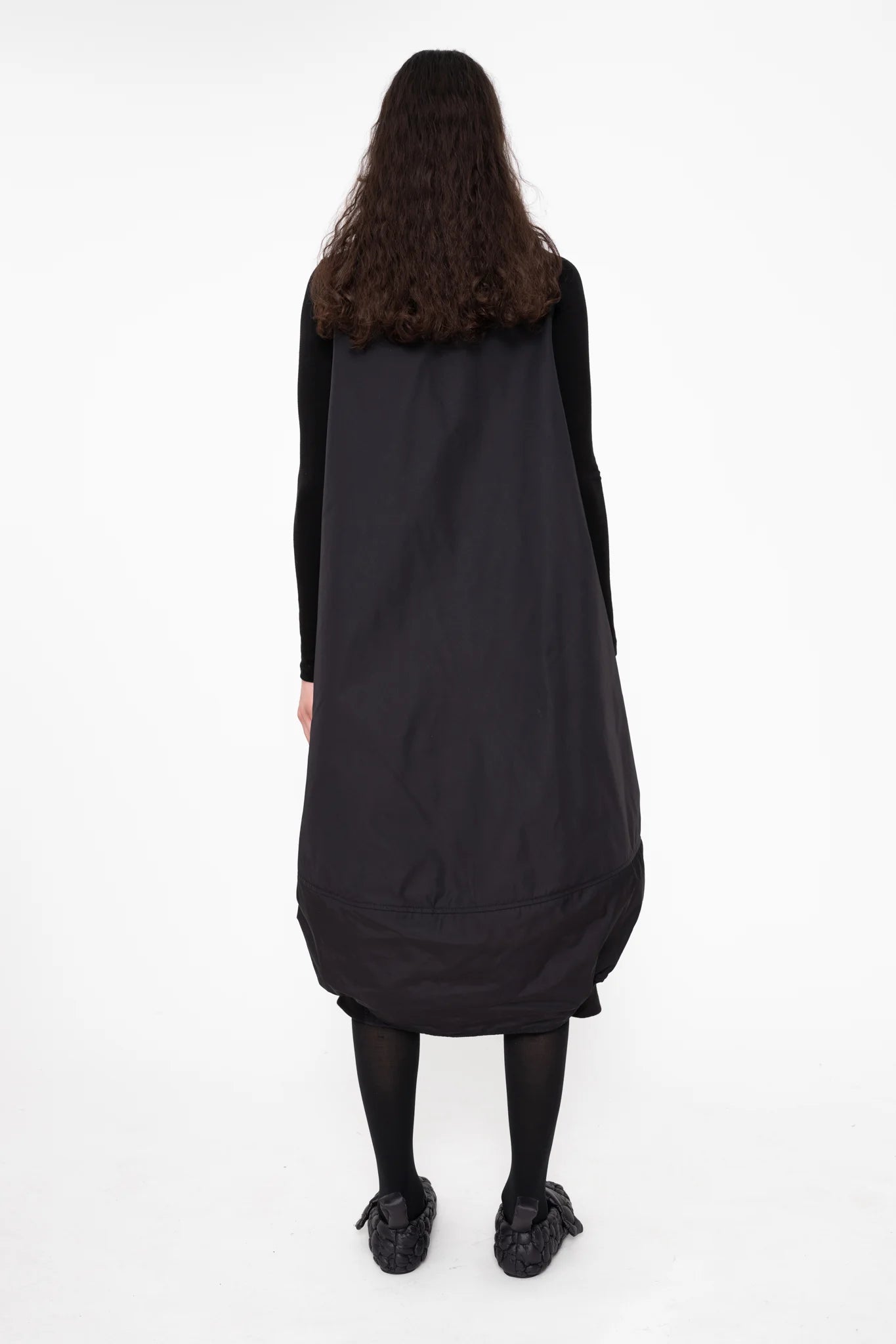 female-wearing-black-bomber-dress-with-big-front-pocket-on-white-background-full-body-back