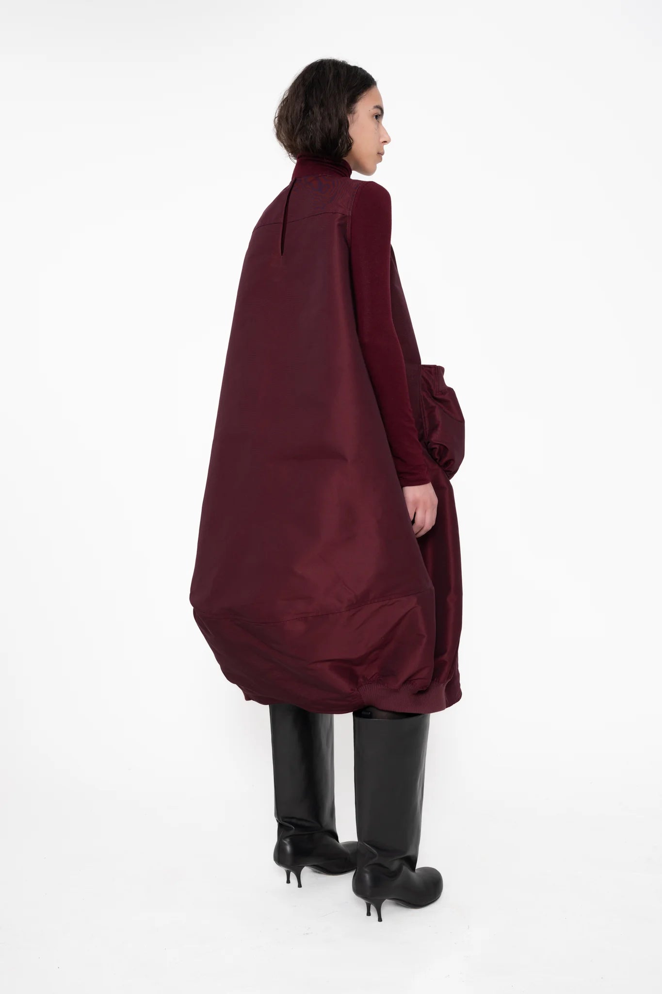 female-wearing-bordeaux-bomber-dress-with-big-front-pocket-on-white-background-full-body-one-quarter