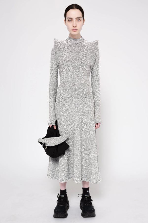 Model wearing silver column dress on a white background, front.