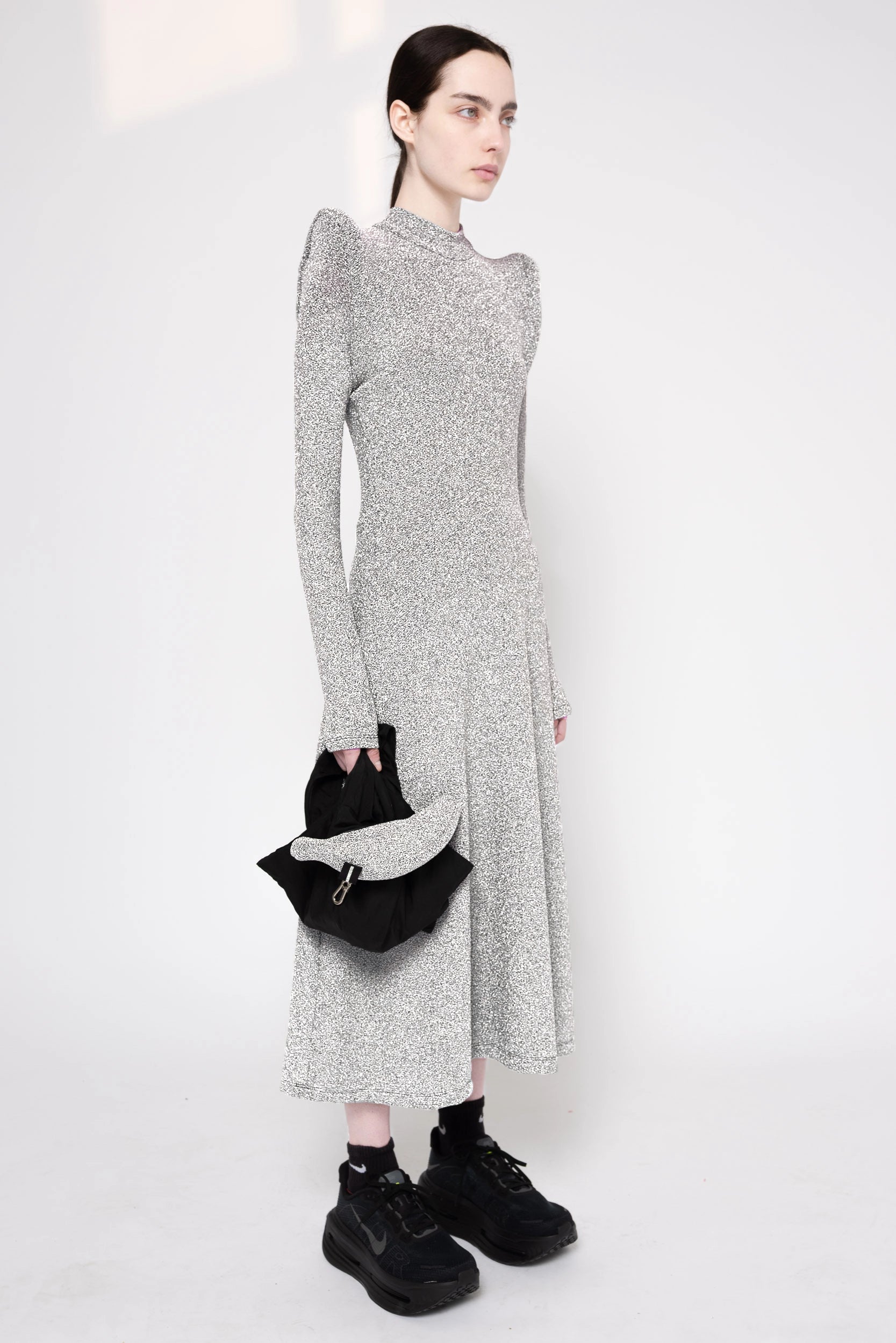 Model wearing silver column dress on a white background, 3/4.