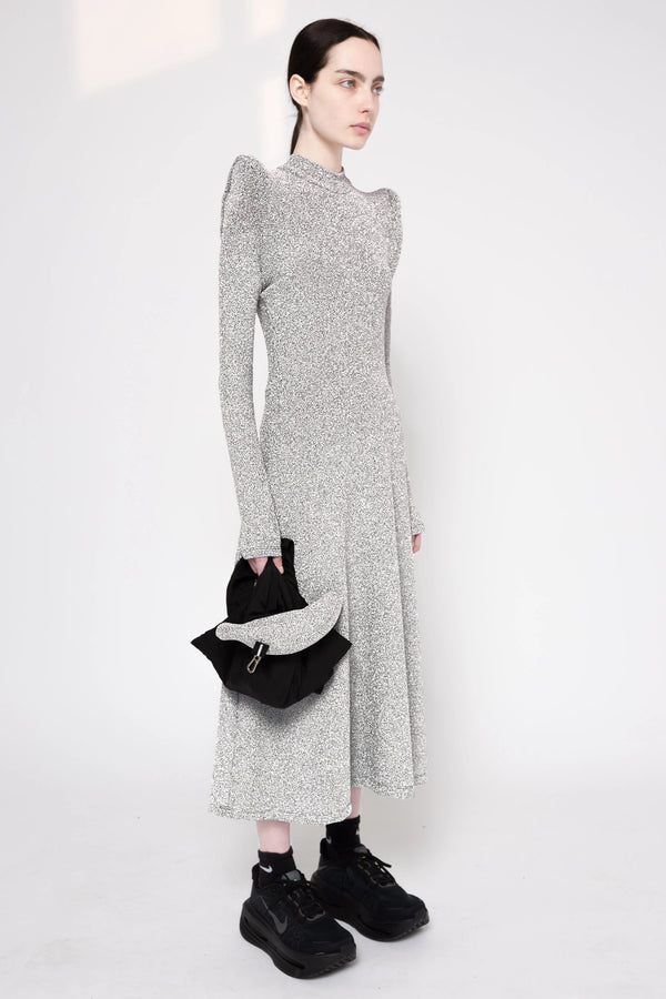 Model wearing silver column dress on a white background, 3/4.