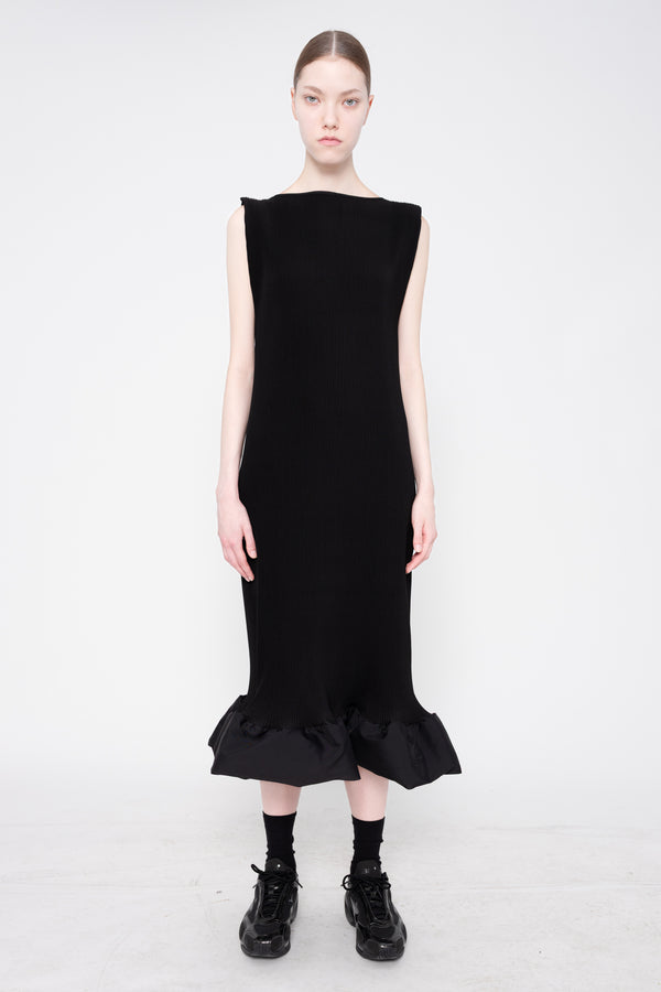 Black dress worn by a model on a white background
