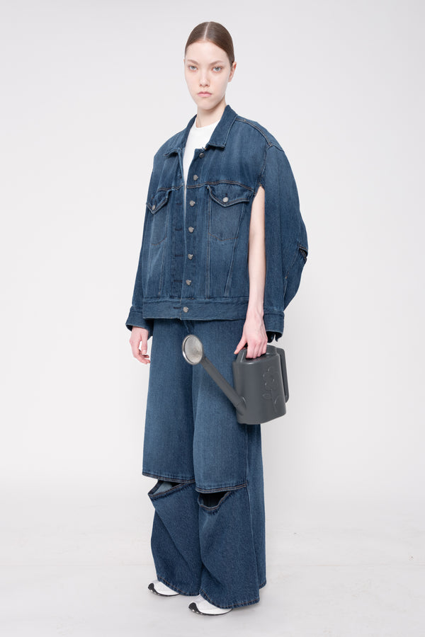 Person wearing a blue denim outfit with a white background
