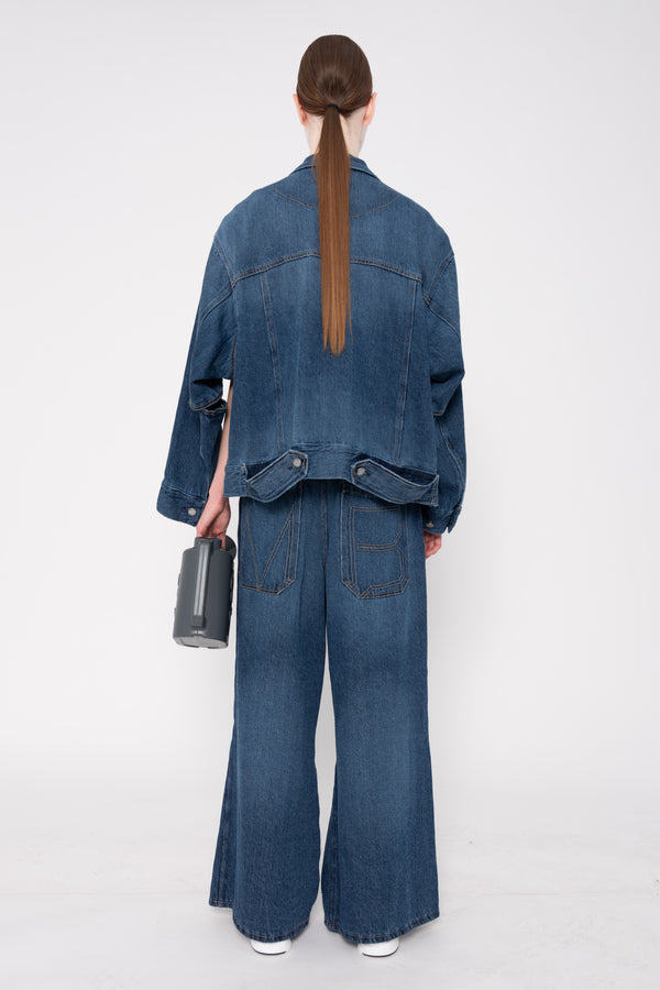 Person wearing a blue denim outfit on a white background