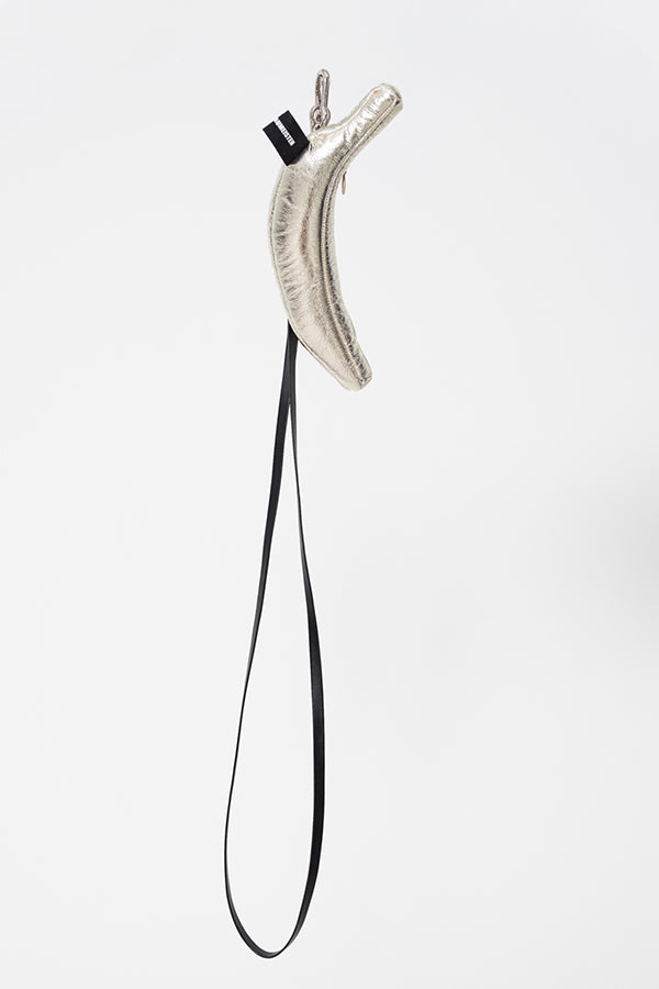 Metallic object with a black cord on a white background