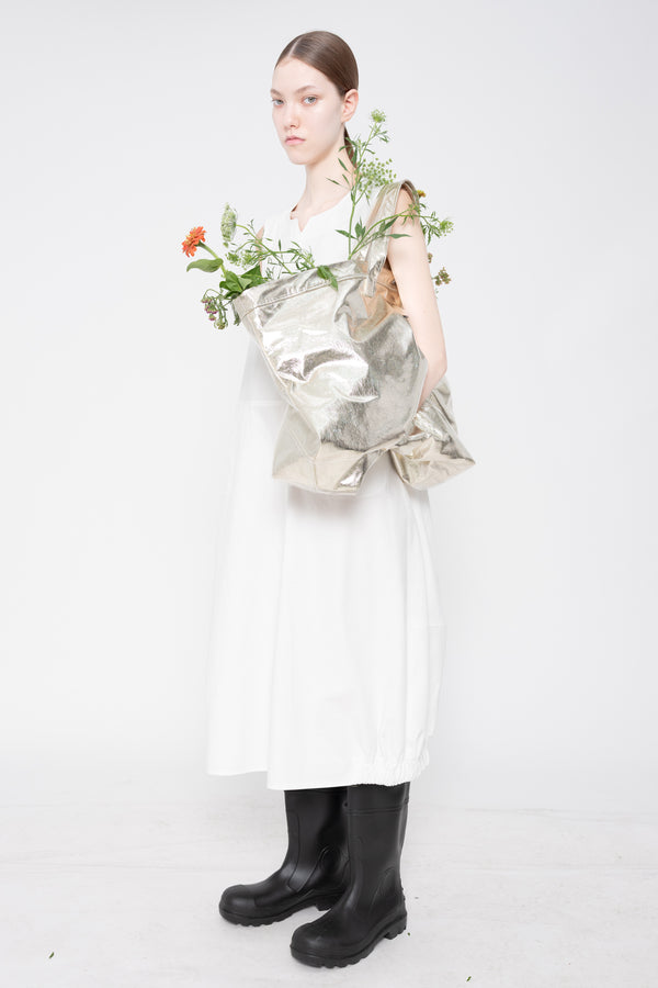 Person holding a floral arrangement against a white background