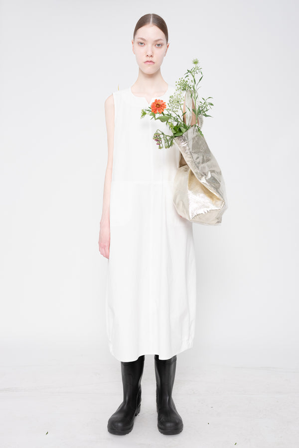 Woman in a white dress holding a bouquet of flowers on a white background