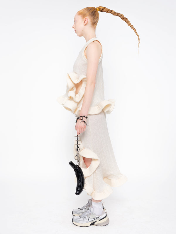 female-wearing-ivory-ruffled-tank-top-and-ivory-ruffled-skirt-with-holes-on-white-background-full-body-side