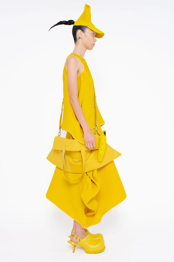female-wearing-yellow-pleated-top-with-ruffles-and-yellow-long-pleated-skirt-with-ruffles-on-white-background-full-body-side