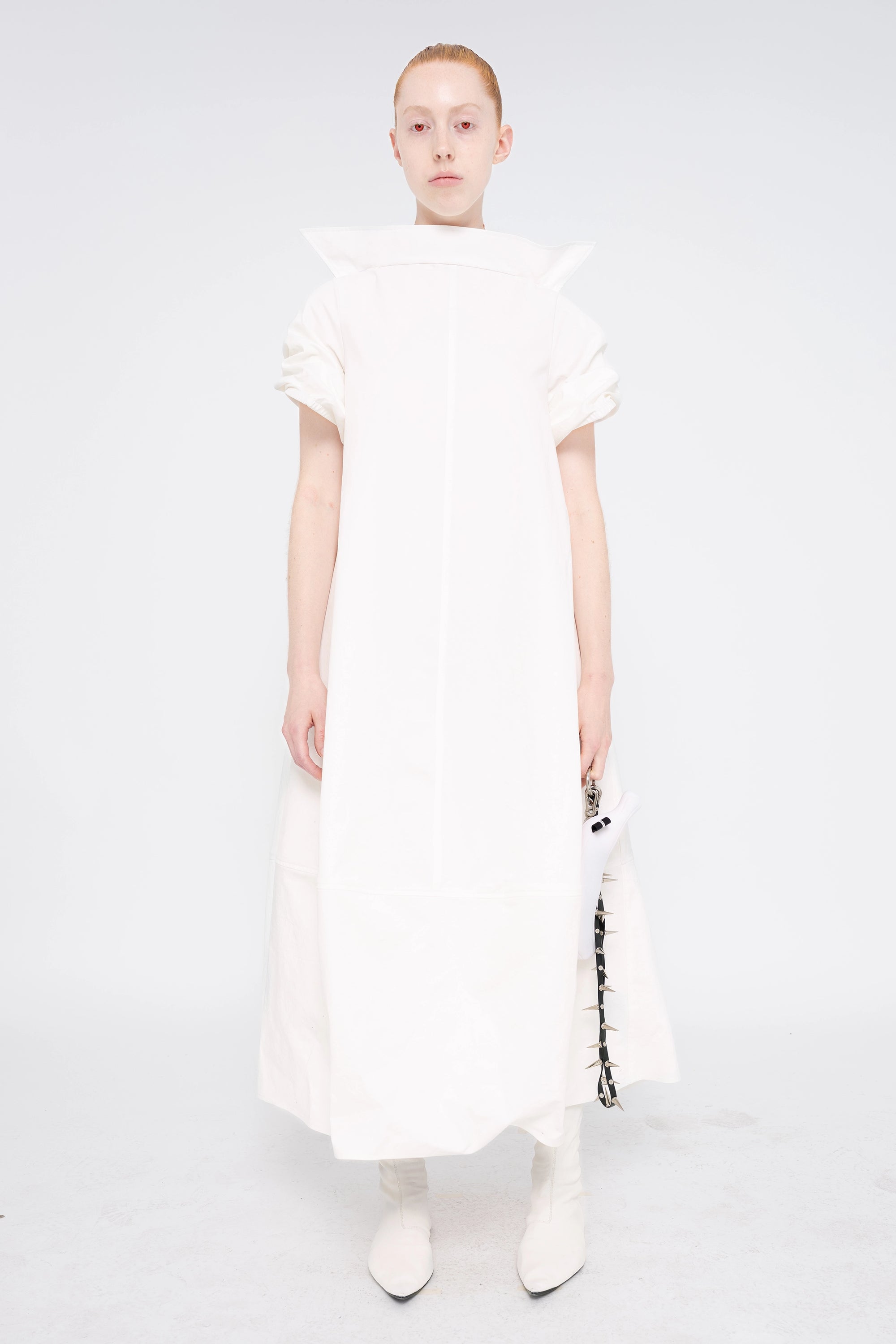 female-wearing-white-maxi-dress-with-stand-up-collar-and-short-pointy-sleeves-on-white-background-full-body-front
