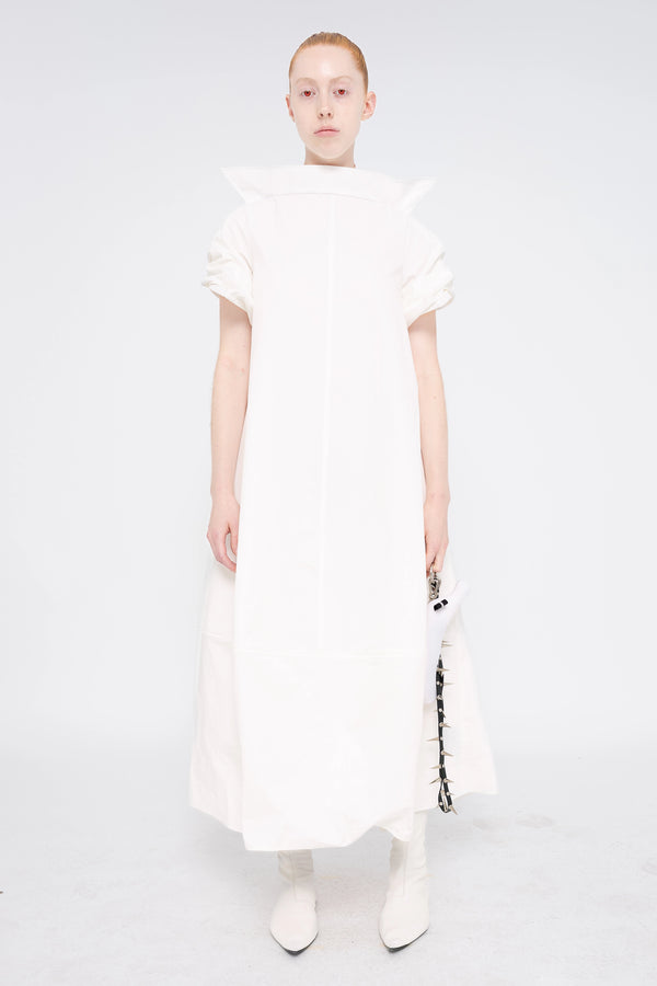 female-wearing-white-maxi-dress-with-stand-up-collar-and-short-pointy-sleeves-on-white-background-full-body-front