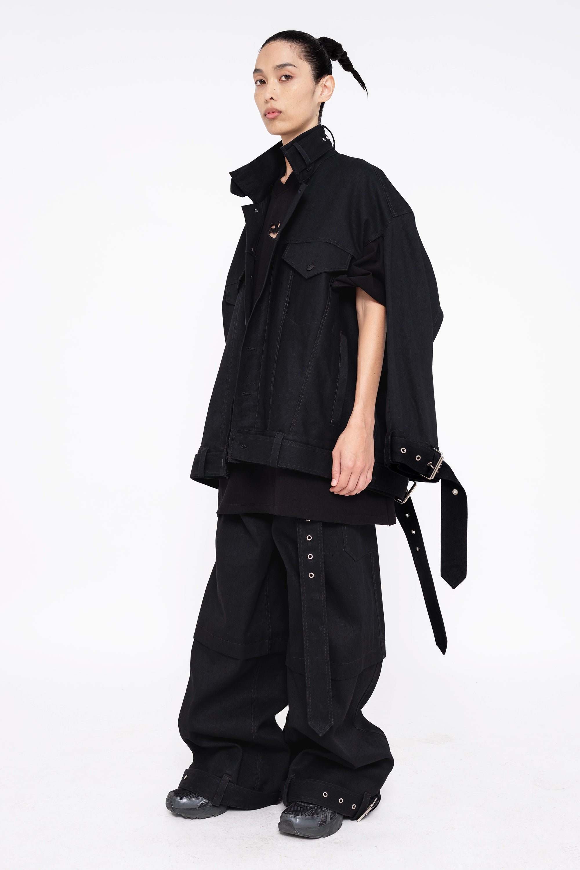 female-wearing-black-smiley-tee-and-black-denim-jacket-on-white-background-full-body-three-quarter