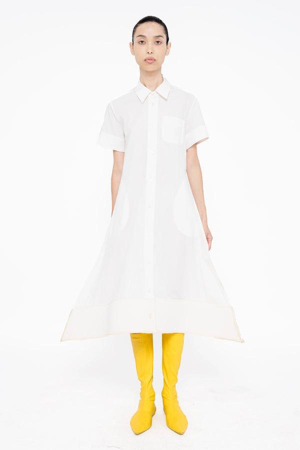 female-wearing-white-shirt-dress-with-pointy-hem-on-white-background-full-body-front