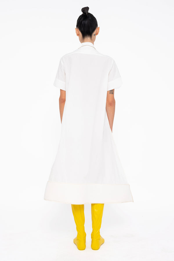 female-wearing-white-shirt-dress-with-pointy-hem-on-white-background-full-body-back