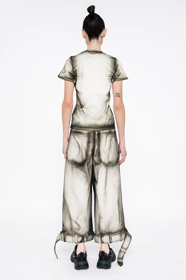female-wearing-white-baby-tee-and-white-denim-pants-with-black-spray-paint-details-onwhite-background-full-body-back