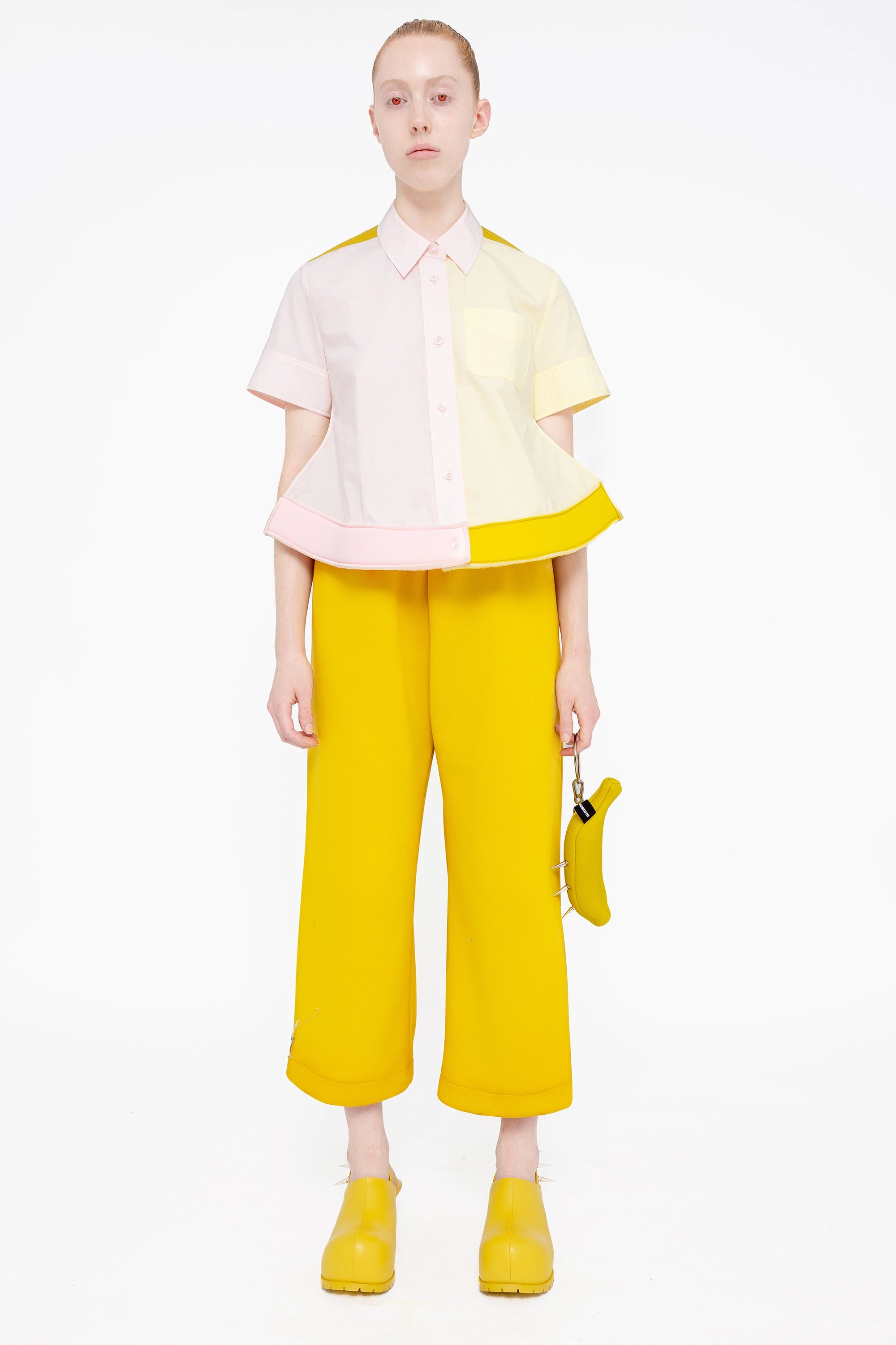 PERSON-WEARING-TRI-COLORED-COLLARED-BUTTON-DOWN-WITH-FOAM-HEM-DETAIL-AND-MUSTARD-YELLOW-SLIT-LOUNGE-PANTS-WITH-MATCHING-YELLOW-DOUBLE-HEEL-MULES-AND-YELLOW-BANANA-TOTE-BAG-FRONT-VIEW