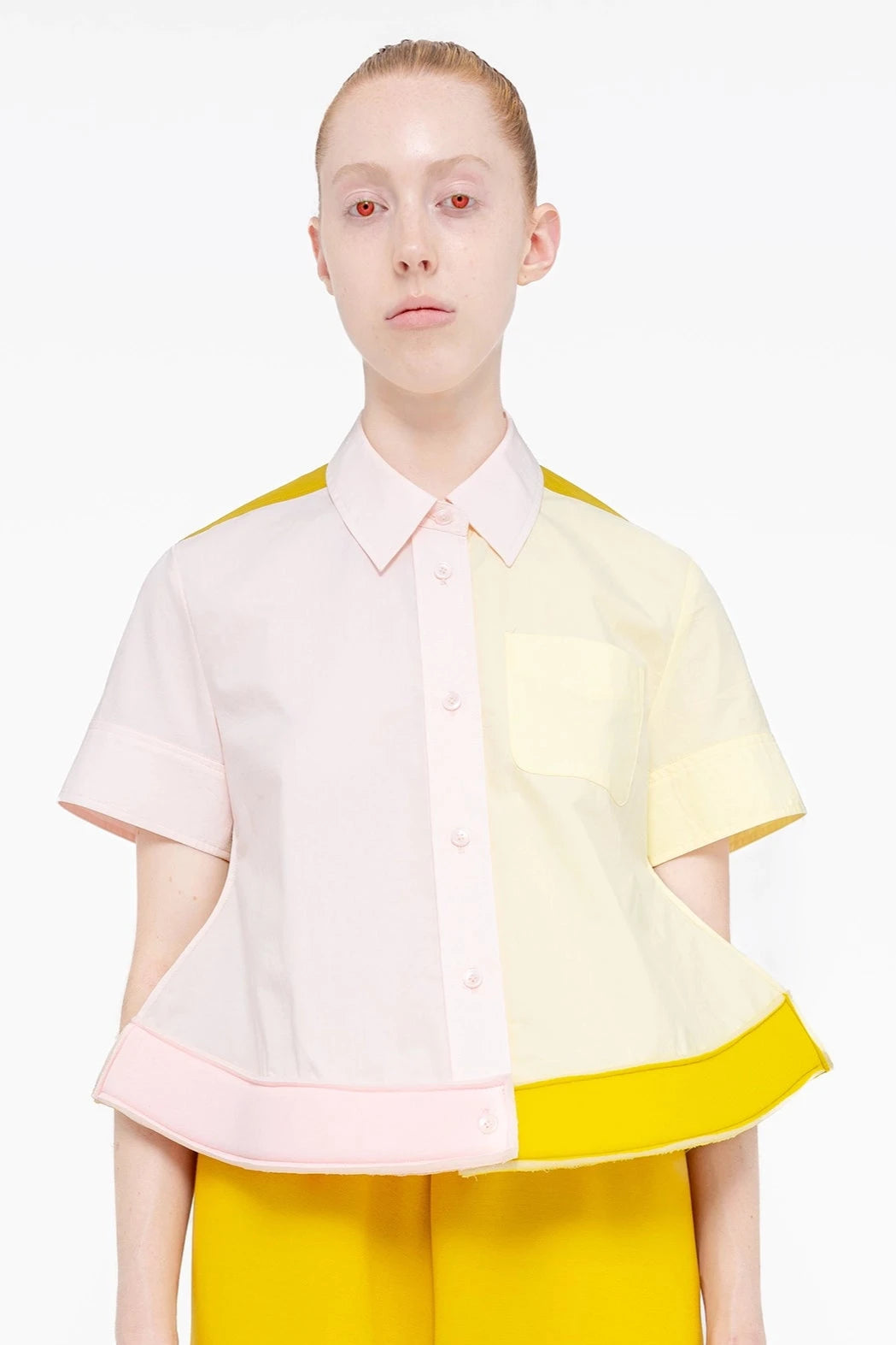 PERSON-WEARING-TRI-COLORED-COLLARED-BUTTON-DOWN-WITH-FOAM-HEM-DETAIL-AND-MUSTARD-YELLOW-PANTS-CLOSE-UP-FRONT-VIEW