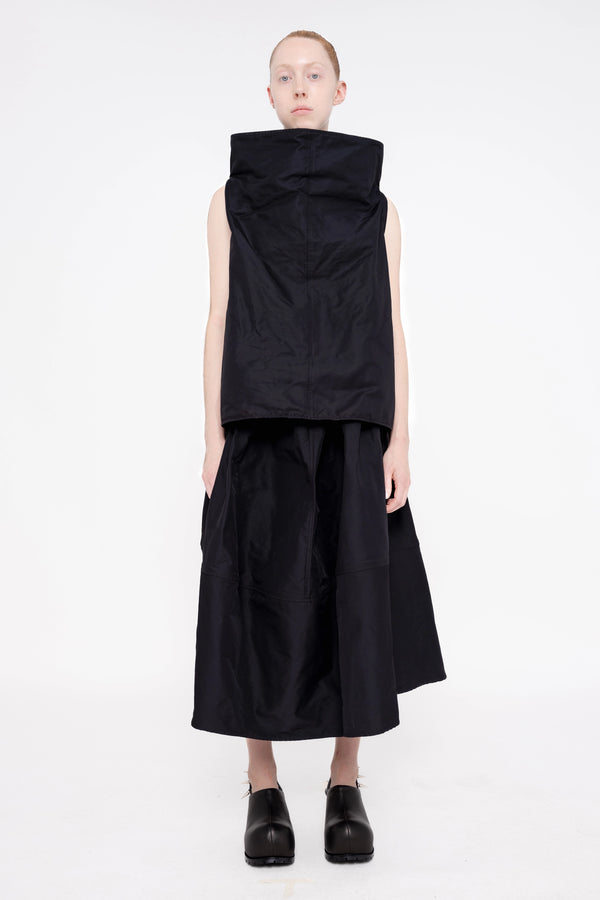 blonde-female-model-white-background-black-sleeveless-boatneck-top-and-skirt-and-black-spikey-doubled-heeled-mules-full-body-front