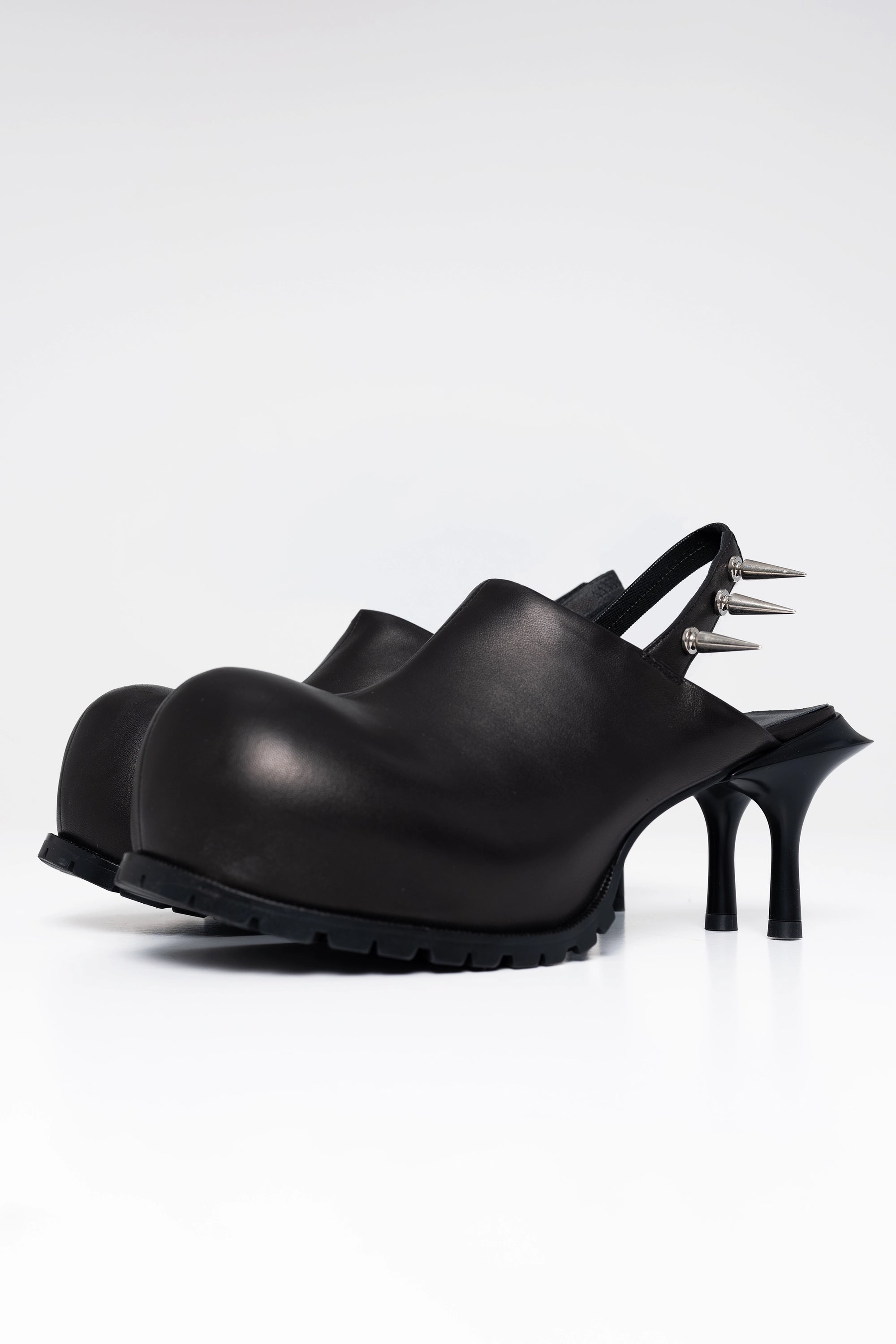 BLACK-DOUBLE-HEELED-MULES-WITH-SPIKE-DETAIL-ON-BACK-STRAP-THREE-QUARTER-VIEW
