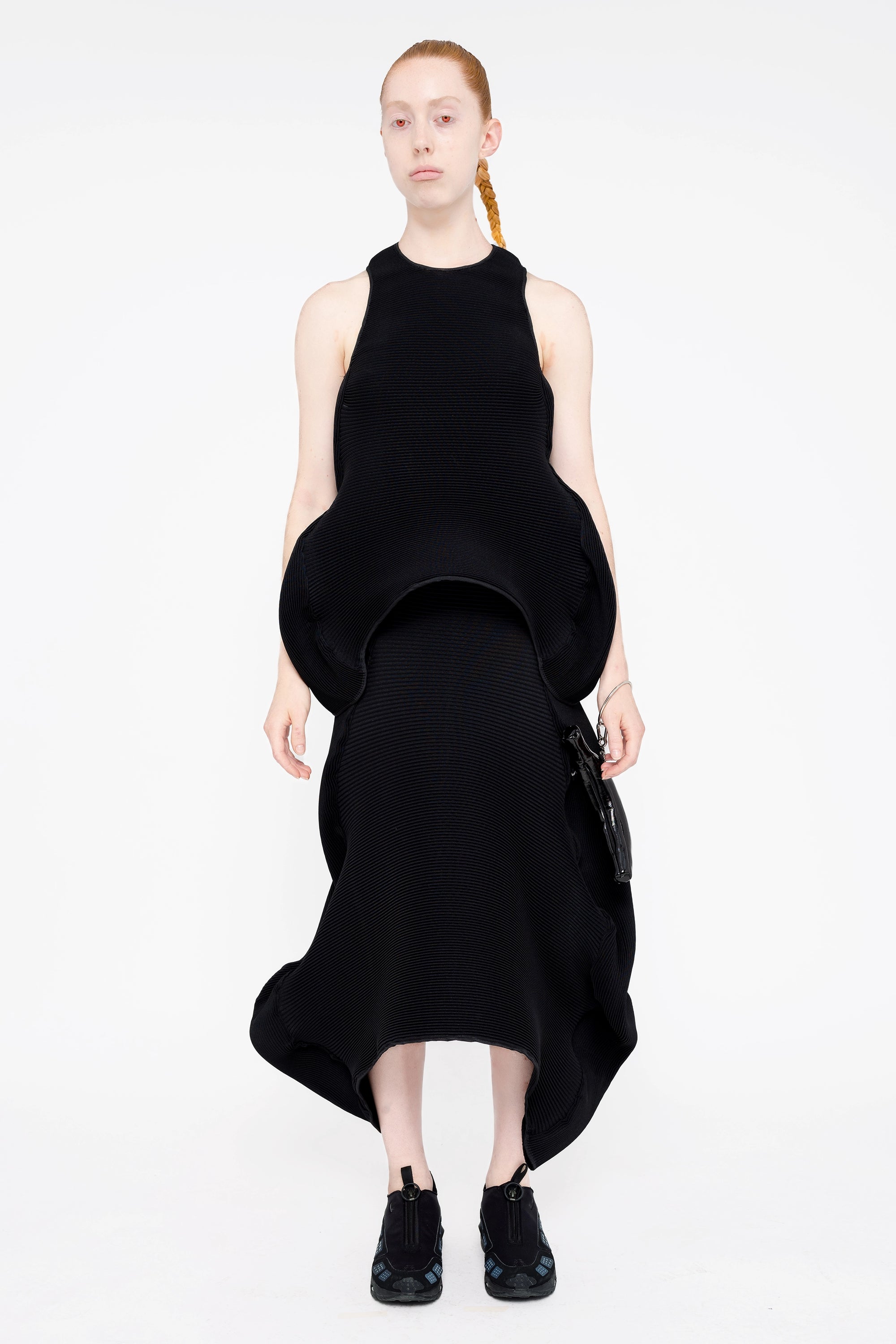female-wearing-black-pleated-top-with-ruffles-and-black-long-pleated-skirt-with-ruffles-on-white-background-full-body-front
