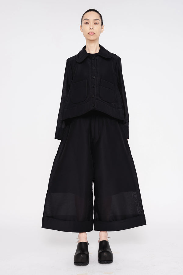 PERSON-WEARING-BLACK-A-LINE-SHIRT-JACKET-AND-MATCHING-PANTS-WITH-BLACK-SPIKED-DOUBLE-HEEL-MULES-FRONT-VIEW