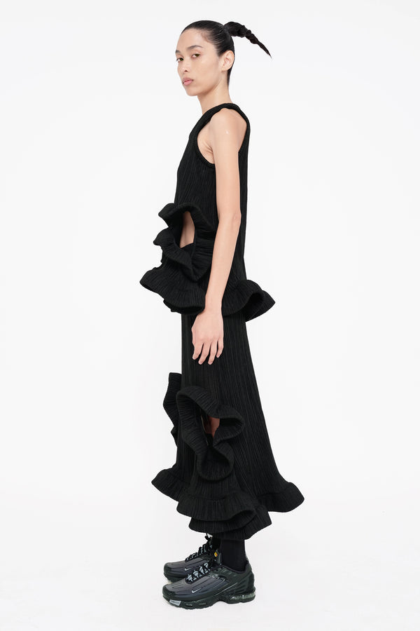 female-wearing-black-ruffled-tank-top-and-black-ruffled-skirt-with-holes-on-white-background-full-body-side-view