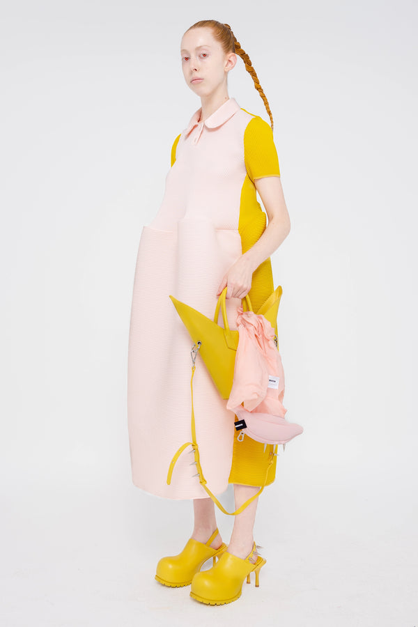 female-wearing-soft-pink-and-yellow-pleated-dress-with-polo-collar-and-ruffled-skirt-on-white-background-full-body-three-quarter