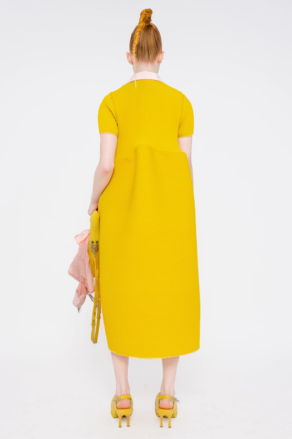 female-wearing-soft-pink-and-yellow-pleated-dress-with-polo-collar-and-ruffled-skirt-on-white-background-full-body-front