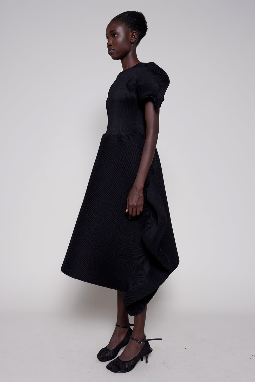 Woman wearing a black dress on a white background