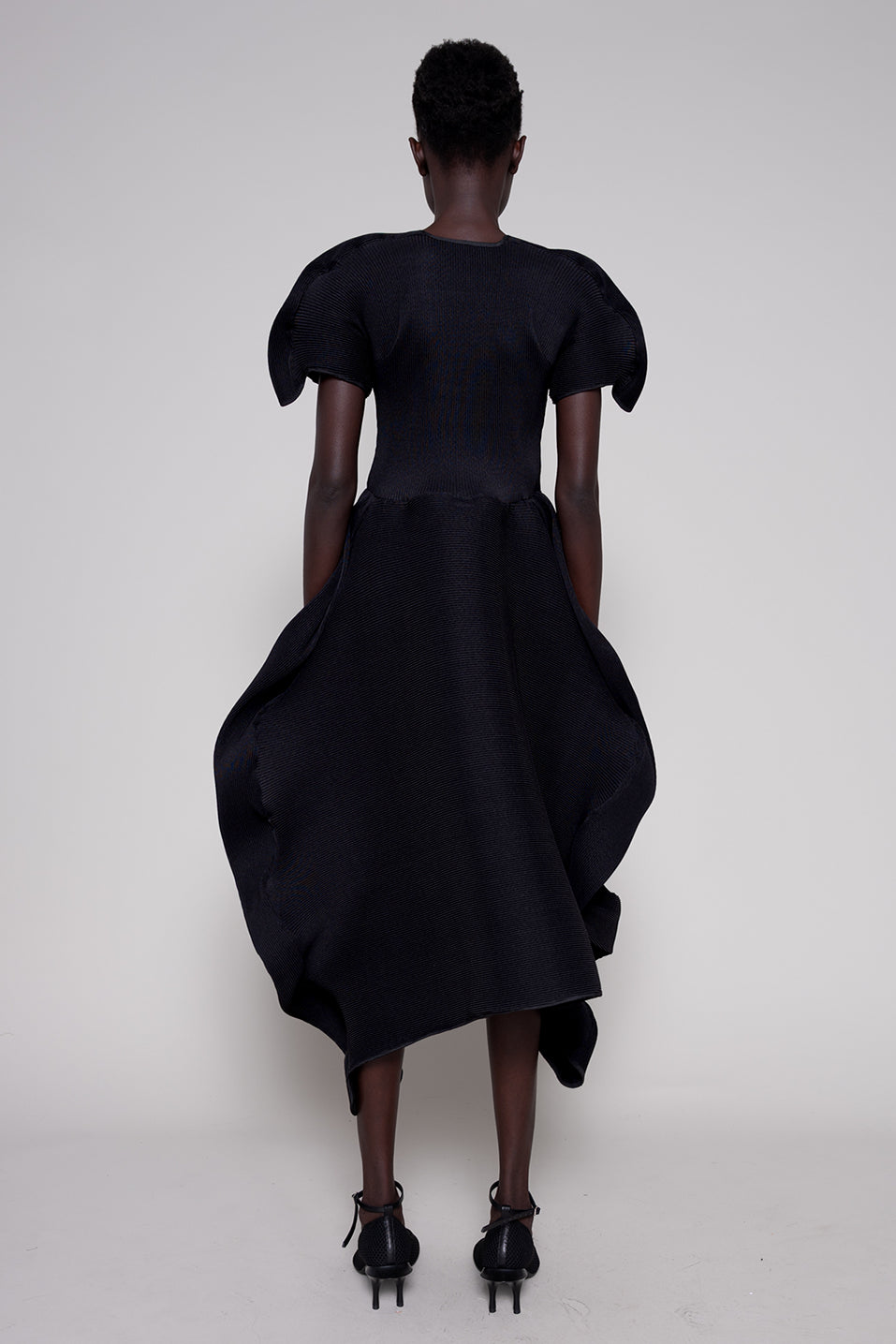Black dress with puffed sleeves on a white background