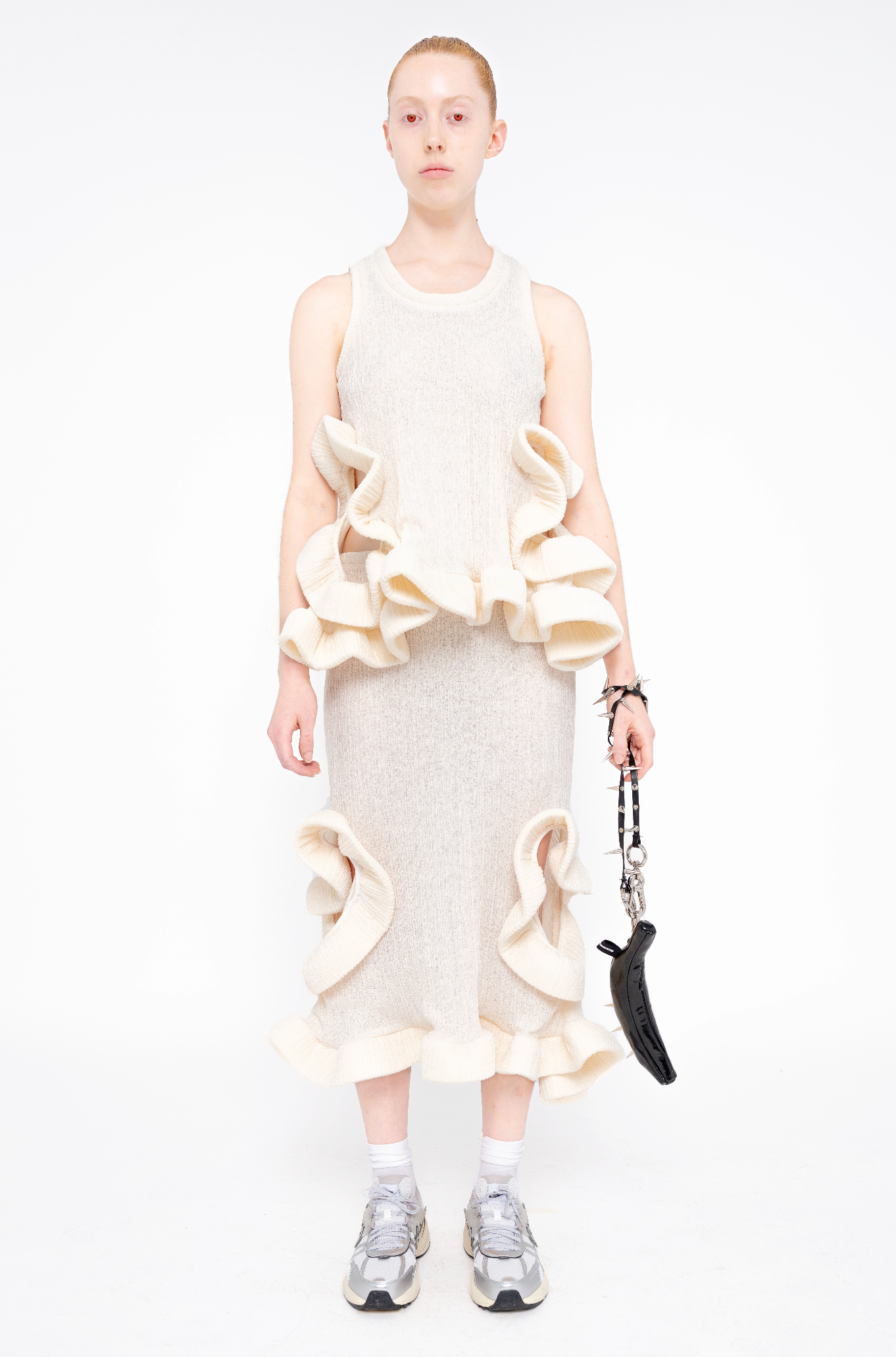 female-wearing-ivory-ruffled-tank-top-and-ivory-ruffled-skirt-with-holes-on-white-background-full-body-front